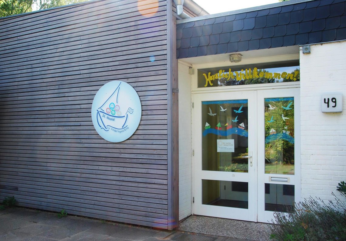 Außenansicht eines Gebäudes mit einem Bootslogo und "Herzlich Willkommen."